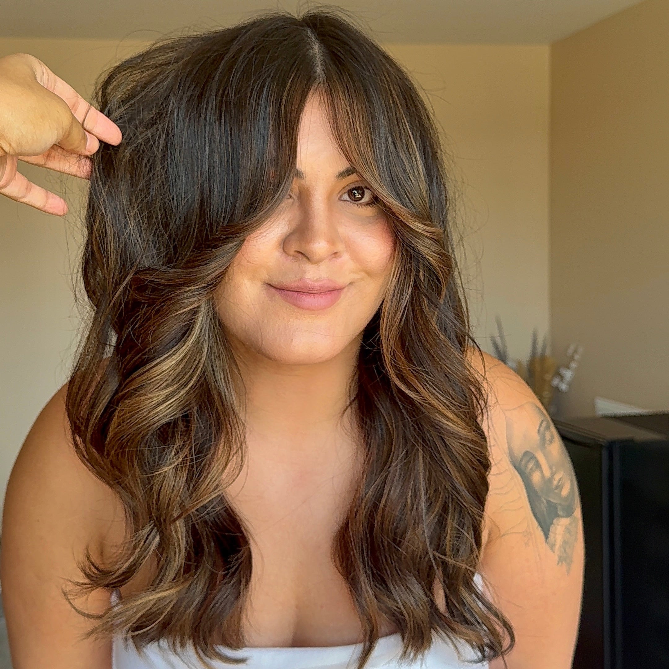 Woman with long, wavy hair in a casual setting